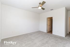Bartow house for rent - a living room with white walls and a ceiling fan