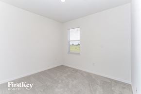 Bartow house for rent - a bedroom with white walls and carpet and a window