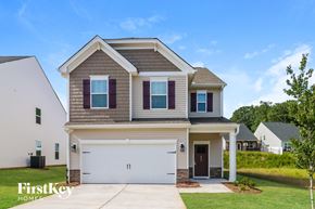 Simpsonville house for rent - a beige and brown house with a white garage door