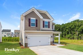Simpsonville house for rent - a beige and brown house with a white garage door