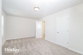 Simpsonville house for rent - a bedroom with white walls and carpet and a door to a closet
