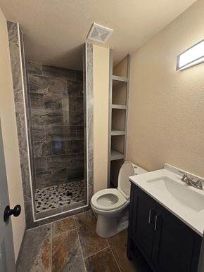 Bay City house for rent - A bathroom with a walk-in shower and a toilet.