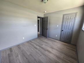 Bay City house for rent - A room with a grey door and a wooden floor.