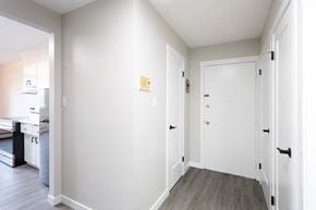 Leduc apartment for rent - a hallway with white walls and white doors and a wood floor
