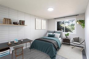 Leduc apartment for rent - a bedroom with a bed and a desk and a window