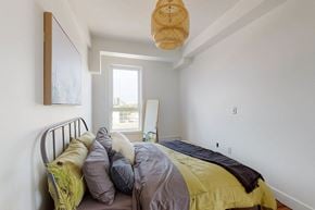 Edmonton apartment for rent - A bedroom with a bed and a window.