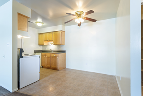 Newport apartment for rent - an empty kitchen with a ceiling fan and a white refrigerator