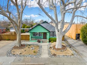 Sacramento house for rent - a green house with two trees in front of it