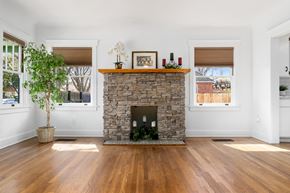 Sacramento house for rent - the living room has a stone fireplace and wooden floors
