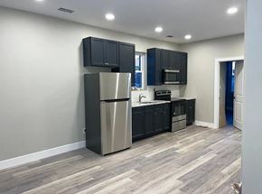 Philadelphia apartment for rent - a kitchen with black cabinets and a stainless steel refrigerator