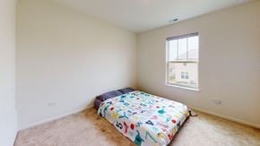 Crown Point house for rent - A bedroom with a bed and a window.