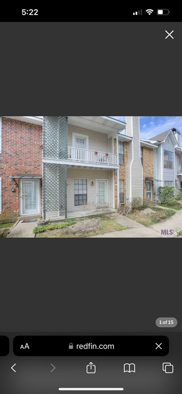 Baton Rouge apartment for rent - A red brick house with a white balcony.