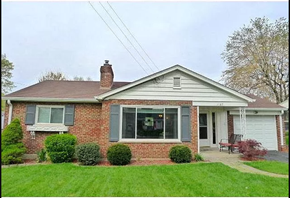 Cincinnati house for rent - a small brick house with a lawn in front of it