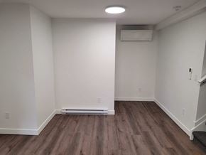 St Jacobs apartment for rent - A room with wooden flooring and white walls.