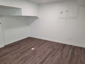 St Jacobs apartment for rent - A room with wooden flooring and a white cabinet with a round object on the floor.