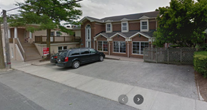 St Jacobs apartment for rent - A black van is parked in front of a house.