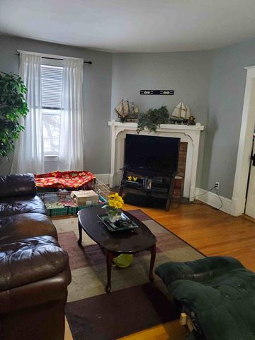 New Glasgow apartment for rent - a living room with a couch a table and a tv