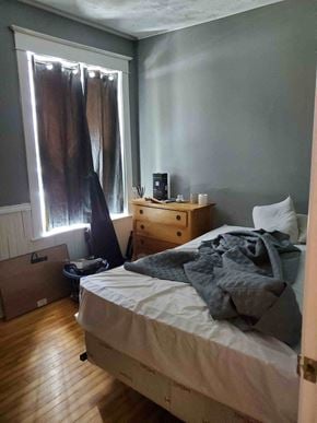 New Glasgow apartment for rent - a bedroom with a bed and a dresser and a window