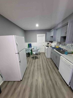 New Glasgow apartment for rent - a kitchen with white appliances and a table and chairs