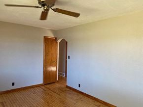 Waterloo house for rent - A room with a ceiling fan and a wooden door.