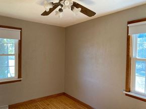 Waterloo house for rent - A room with a ceiling fan and two windows.