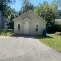 Collinsville apartment for rent - a small tan house with a white door and a driveway