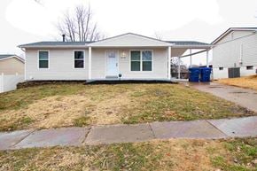 Fenton house for rent - the front of a white house with a yard and a driveway