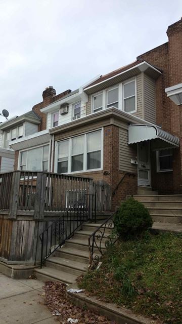 Philadelphia house for rent - A brown house with a black iron fence.