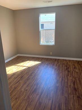 Dodge City apartment for rent - A room with wooden flooring and a window.