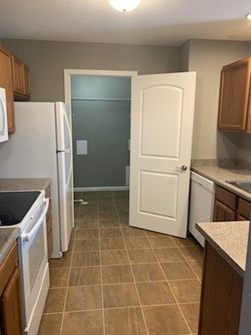 Dodge City apartment for rent - A kitchen with a white refrigerator and a white door.