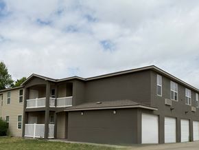 Dodge City apartment for rent - A two-story apartment building with a balcony on the second floor.