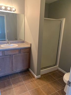 Dodge City apartment for rent - A bathroom with a sink, mirror, and toilet.