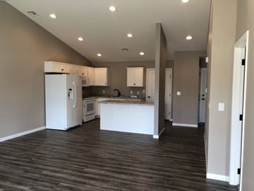 Dodge City apartment for rent - A kitchen with white appliances and cabinets is shown.