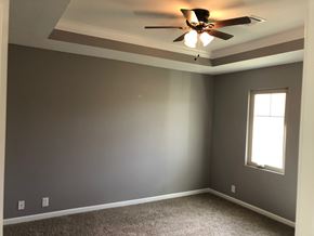 Dodge City apartment for rent - A room with a ceiling fan and a window.