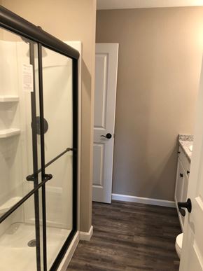 Dodge City apartment for rent - A bathroom with a glass shower door and a white toilet.