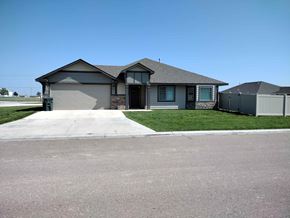 Dodge City apartment for rent - A house with a grey roof and a garage door.