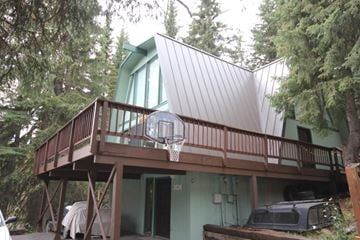 Whitefish apartment for rent - A house with a green exterior and a balcony.
