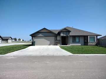 Dodge City apartment for rent - A house with a grey roof and a driveway in front.
