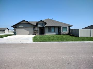 Dodge City apartment for rent - A house with a grey roof and a green lawn.