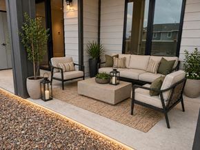 Dodge City apartment for rent - A patio with a couch, chair, and table with pillows.