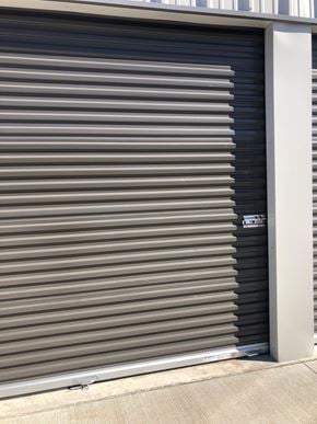 Dodge City apartment for rent - A closed grey shutter door with a white frame.