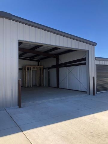 Dodge City apartment for rent - A large white building with a closed garage door.