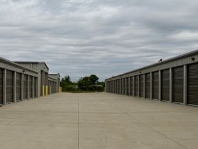 Dodge City apartment for rent - A long row of storage units with closed grey doors.