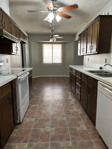 Snyder house for rent - an empty kitchen with a ceiling fan and a sink