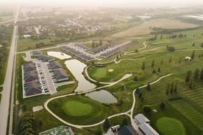 La Broquerie apartment for rent - A golf course with a building in the background.