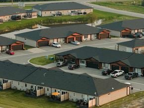 La Broquerie apartment for rent - A bird's eye view of a residential area with houses and cars.