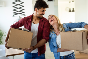St. Ignace apartment for rent - a man and a woman laughing while holding boxes