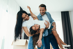 St. Ignace apartment for rent - two women and a man playing with a child in a living room