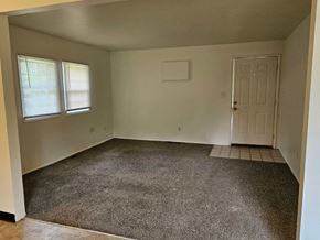 Youngstown house for rent - a empty room with a carpeted floor and a white door