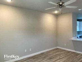 Lewisville house for rent - a empty living room with a ceiling fan